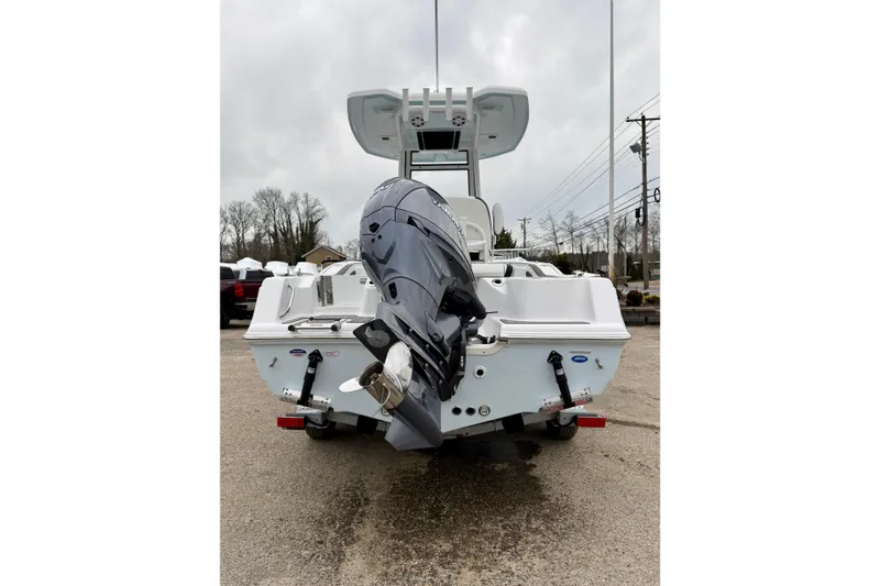 Slide: The Image of 2026 Tidewater 210 CC Adventure boat with powerful outboard motor, parked on a trailer. - 11