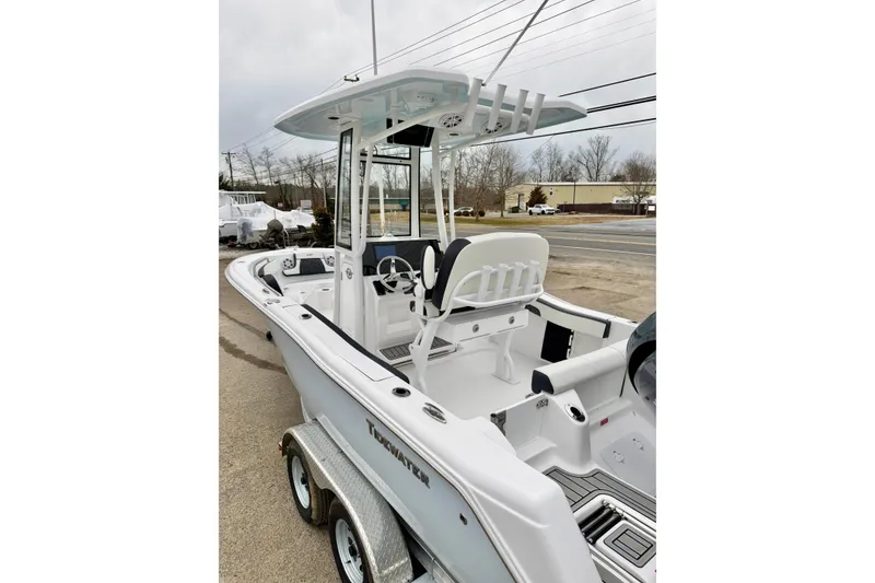 Slide: The Image of 2026 Tidewater 210 CC Adventure boat on trailer, featuring sleek design and spacious deck. - 14