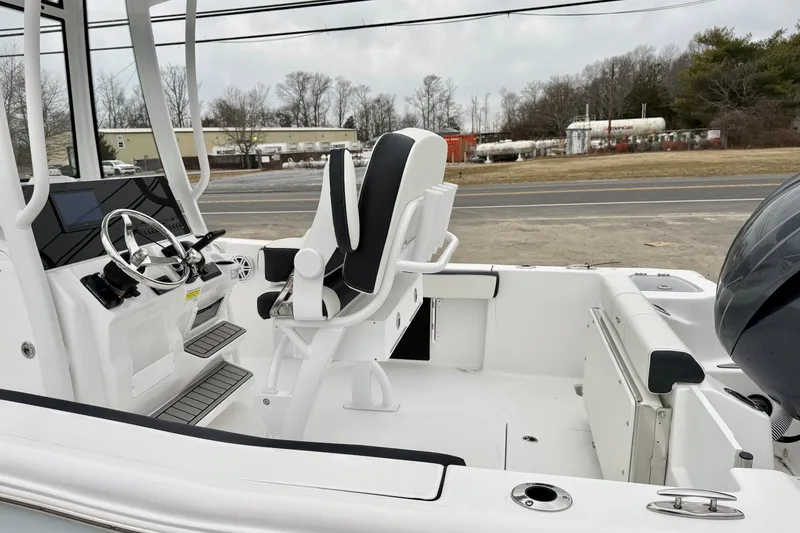 Slide: The Image of 2026 Tidewater 210 CC Adventure boat interior with steering wheel and seating. - 16