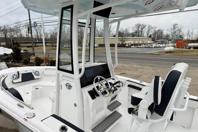 Slide: The Image of 2026 Tidewater 210 CC Adventure boat interior with modern helm and seating. - 18