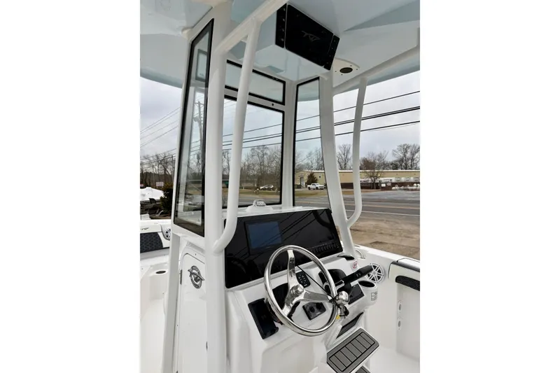 Slide: The Image of 2026 Tidewater 210 CC Adventure boat console with steering wheel and electronics. - 22