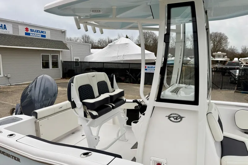Slide: The Image of 2026 Tidewater 210 CC Adventure boat interior at a marine dealership. - 28