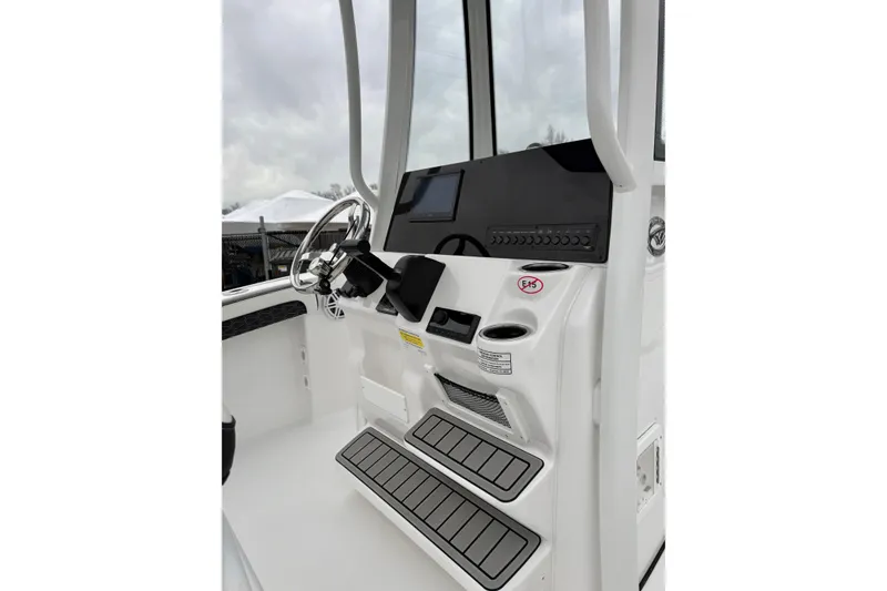 Slide: The Image of 2026 Tidewater 210 CC Adventure boat console with steering wheel and controls. - 30