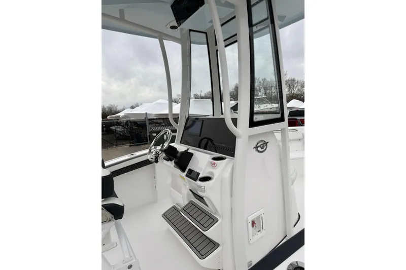Slide: The Image of 2026 Tidewater 210 CC Adventure boat console with steering wheel and controls. - 31