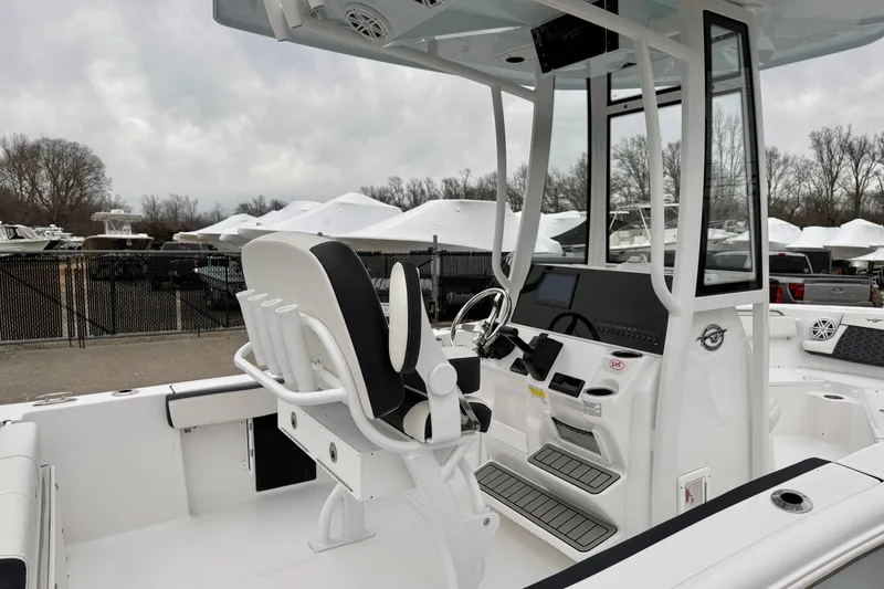 Slide: The Image of 2026 Tidewater 210 CC Adventure boat interior with helm and seating. - 32