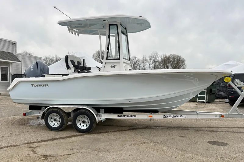Slide: The Image of 2026 Tidewater 210 CC Adventure boat on trailer, parked outdoors. - 8