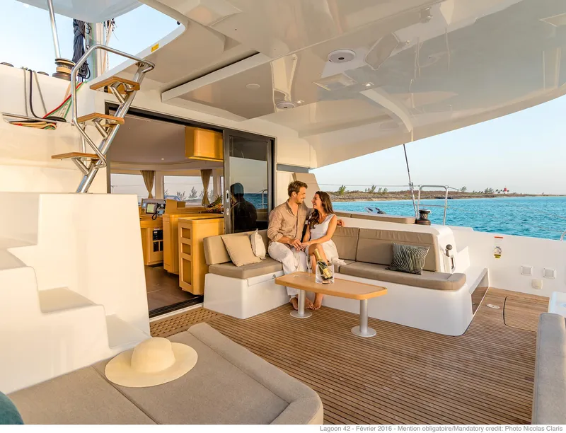 Slide: The Image of Couple relaxing on Lagoon 42 Millenium yacht, 2025 model, with ocean view. - 5