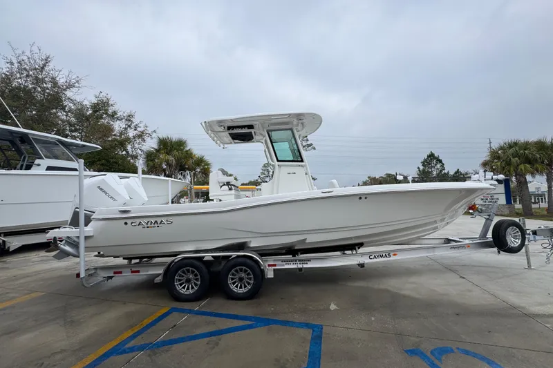Slide: The Image of 2026 Caymas 281 HB boat on trailer, parked outdoors, overcast sky. - 10