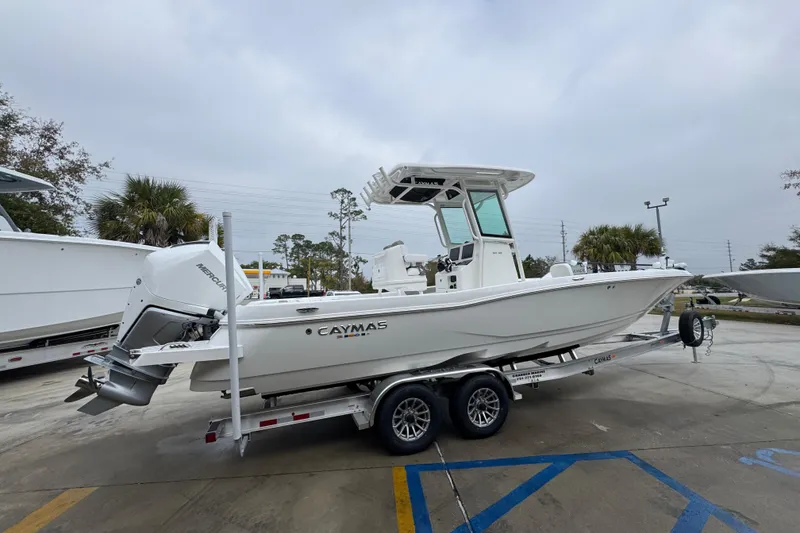 Slide: The Image of 2026 Caymas 281 HB boat on trailer in parking lot, side view. - 11