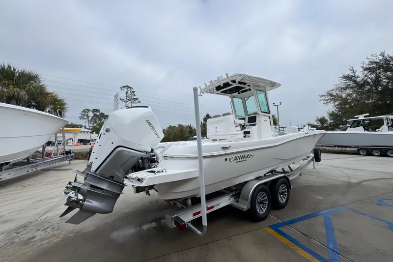 Slide: The Image of 2026 Caymas 281 HB boat on trailer, featuring a powerful Mercury engine. - 12
