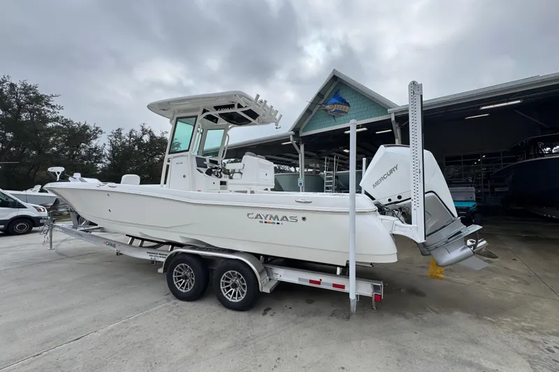 Slide: The Image of 2026 Caymas 281 HB boat on trailer, parked outdoors near a building. - 17