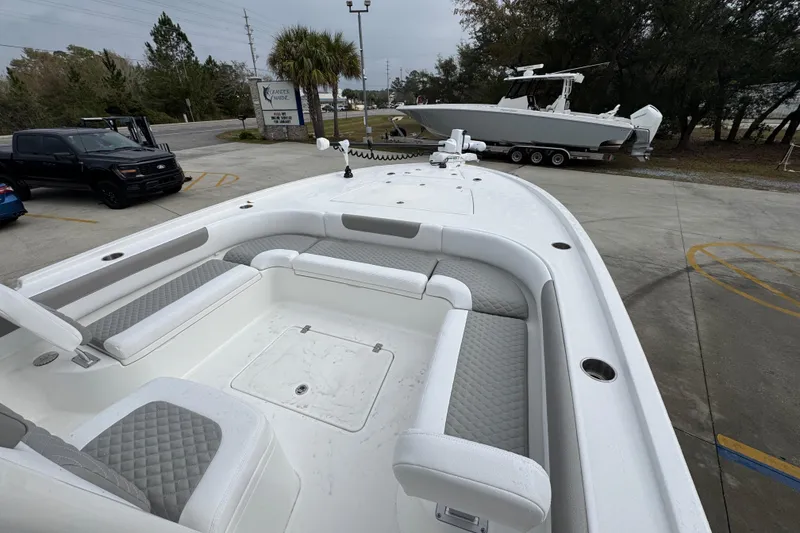 Slide: The Image of 2026 Caymas 281 HB boat with spacious seating and modern design in a parking area. - 18
