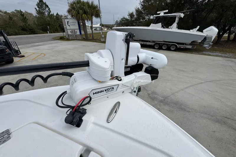 Slide: The Image of 2026 Caymas 281 HB with Minn Kota Instinct motor in a marina setting. - 21