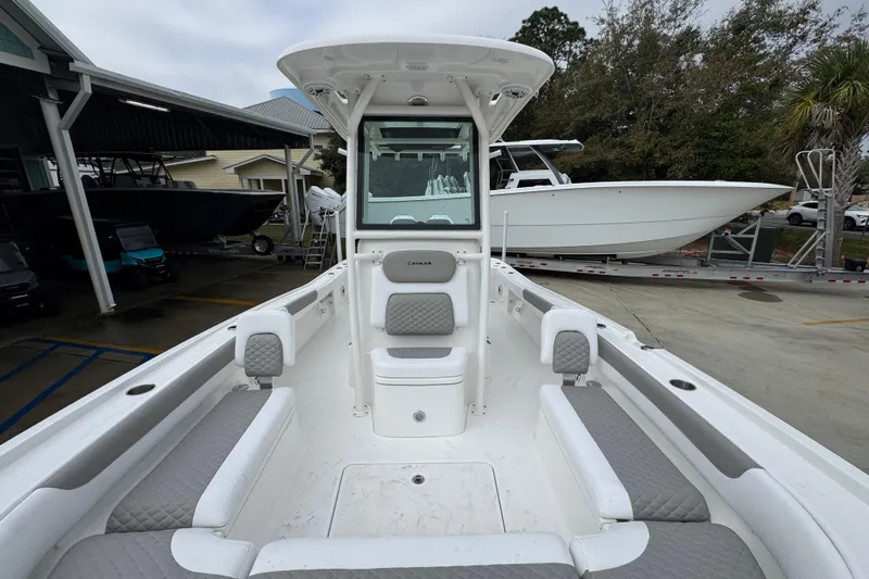 Slide: The Image of 2026 Caymas 281 HB boat interior with cushioned seating and center console. - 25