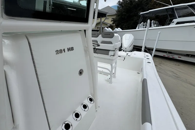 Slide: The Image of 2026 Caymas 281 HB boat interior with seating and storage compartments. - 26