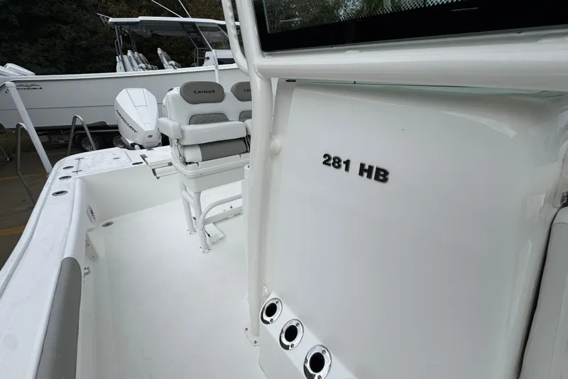Slide: The Image of 2026 Caymas 281 HB boat interior with seating and console details. - 27