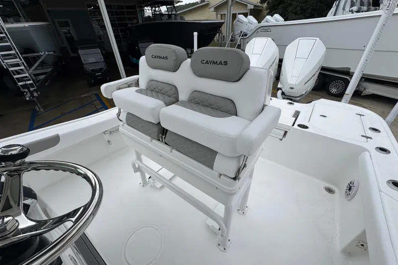 Slide: The Image of 2026 Caymas 281 HB boat with dual cushioned seats and steering wheel. - 29