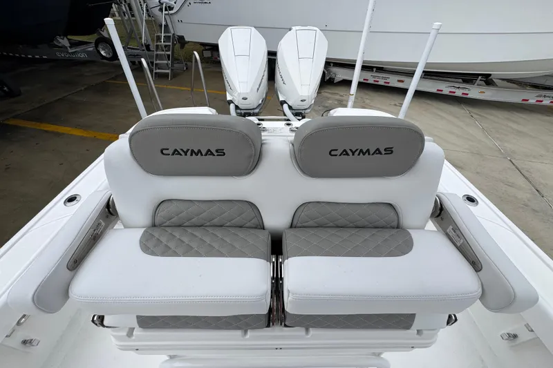 Slide: The Image of 2026 Caymas 281 HB boat seats with gray and white upholstery, docked outdoors. - 30