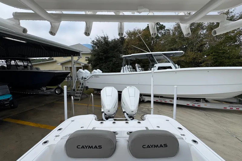 Slide: The Image of 2026 Caymas 281 HB boat with dual engines, parked in a marina setting. - 31