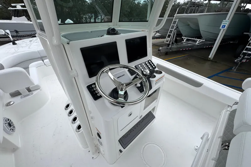 Slide: The Image of 2026 Caymas 281 HB boat cockpit with dual screens and steering wheel. - 33