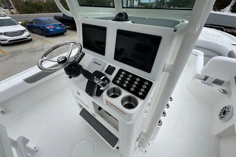 Slide: The Image of 2026 Caymas 281 HB boat helm with dual screens and modern controls. - 35