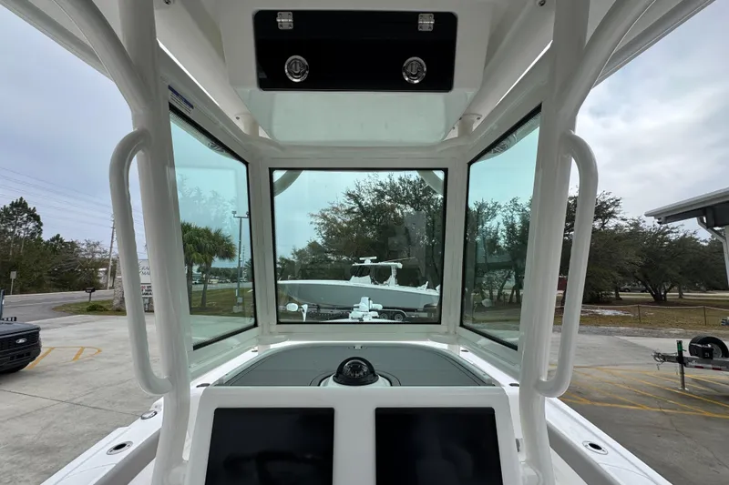 Slide: The Image of Interior view of 2026 Caymas 281 HB boat cockpit with clear windshield. - 36