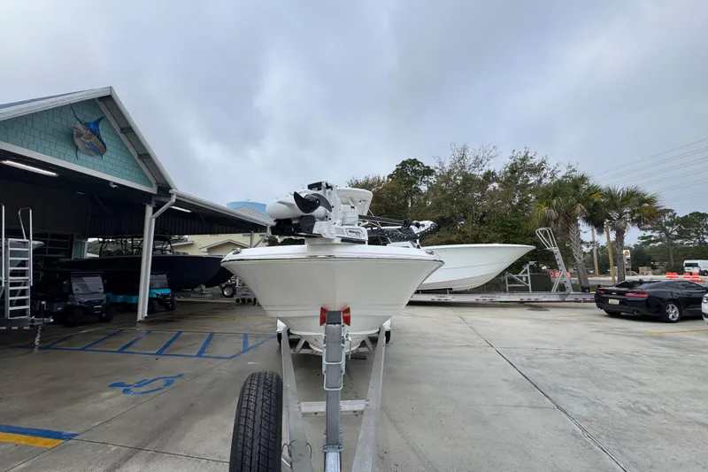 Slide: The Image of 2026 Caymas 281 HB boat on trailer at dealership, overcast sky. - 6