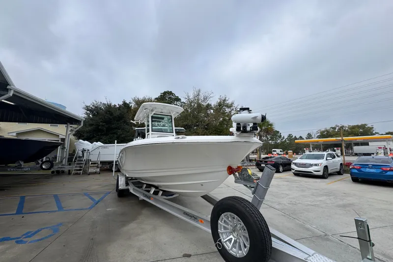 Slide: The Image of 2026 Caymas 281 HB boat on trailer in parking lot, overcast sky. - 7