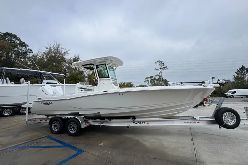 Slide: The Image of 2026 Caymas 281 HB boat on trailer, parked outdoors, overcast sky. - 9