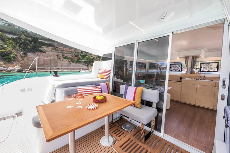 Slide: The Image of Luxurious Lagoon 38 yacht interior with dining area, scenic ocean view, and modern amenities, 2025 model. - 15