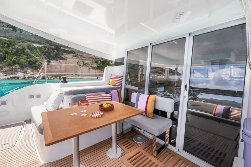 Slide: The Image of Luxurious Lagoon 38 yacht interior, featuring a stylish dining area with scenic ocean views. - 17