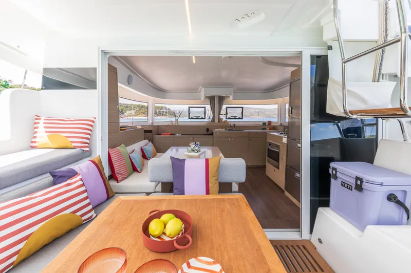 Slide: The Image of Luxurious interior of 2025 Lagoon 38 catamaran with colorful cushions and modern kitchen. - 23