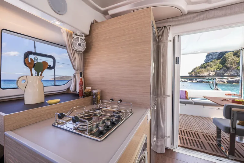 Slide: The Image of Modern kitchen interior of 2025 Lagoon 38 yacht with ocean view. - 33