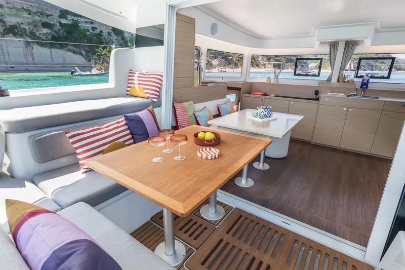 Slide: The Image of Luxurious interior of 2025 Lagoon 38 catamaran with modern kitchen and colorful seating. - 36