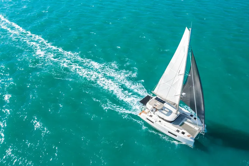Slide: The Image of 2025 Lagoon 38 catamaran sailing on turquoise ocean waters. - 79