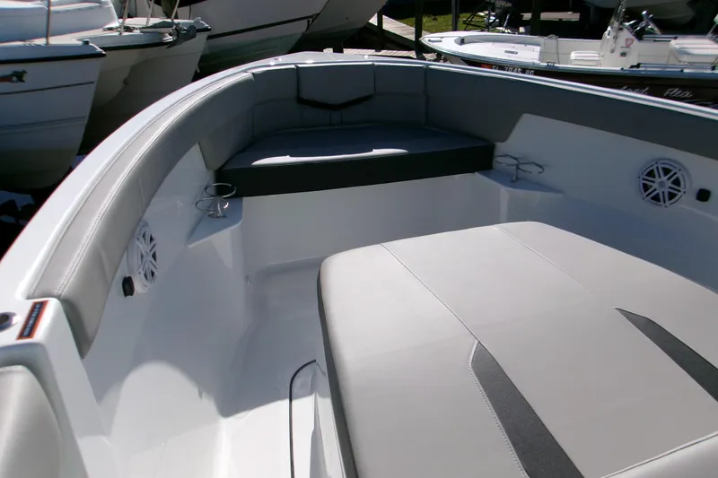 Slide: The Image of 2026 Monterey Elite 25 OB boat interior with cushioned seating and cup holders. - 15