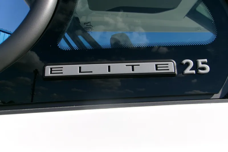 Slide: The Image of 2026 Monterey Elite 25 OB boat logo on window with reflection. - 22