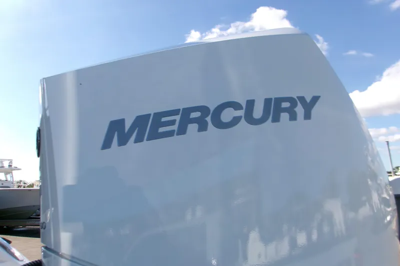 Slide: The Image of Mercury outboard engine on 2026 Monterey Elite 25 OB boat under blue sky. - 6