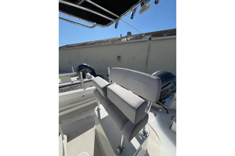 Slide: The Image of 2022 Parker 2100 Special Edition boat interior with seating and dual engines. - 11