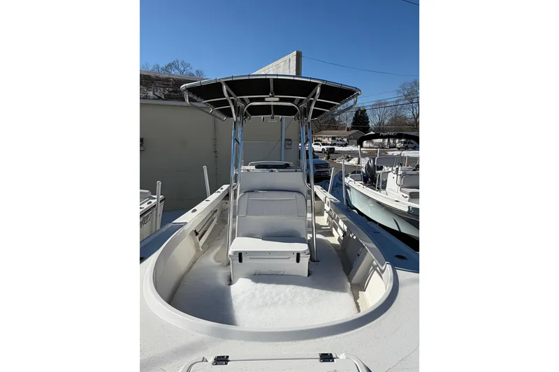 Slide: The Image of 2022 Parker 2100 Special Edition boat with T-top and seating, docked outdoors. - 5