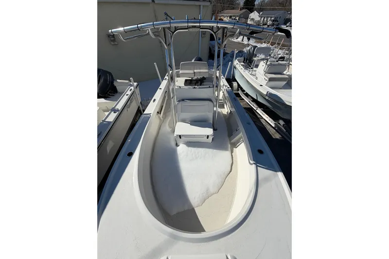 Slide: The Image of 2022 Parker 2100 Special Edition boat with T-top and seating, docked outdoors. - 9