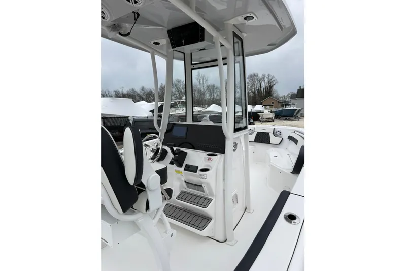 Slide: The Image of 2026 Tidewater 220 CC Adventure boat interior with modern helm and seating. - 14