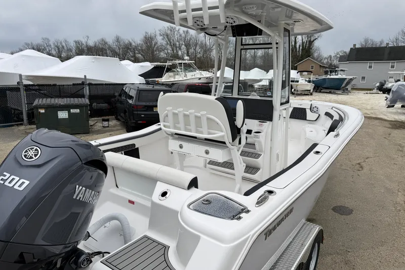 Slide: The Image of 2026 Tidewater 220 CC Adventure boat with Yamaha engine, parked outdoors. - 15