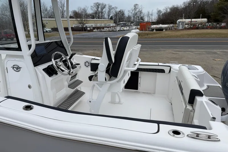 Slide: The Image of 2026 Tidewater 220 CC Adventure boat interior with helm and seating. - 17