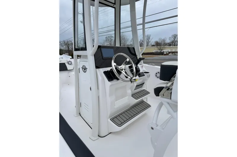 Slide: The Image of 2026 Tidewater 220 CC Adventure boat console with steering wheel and controls. - 18
