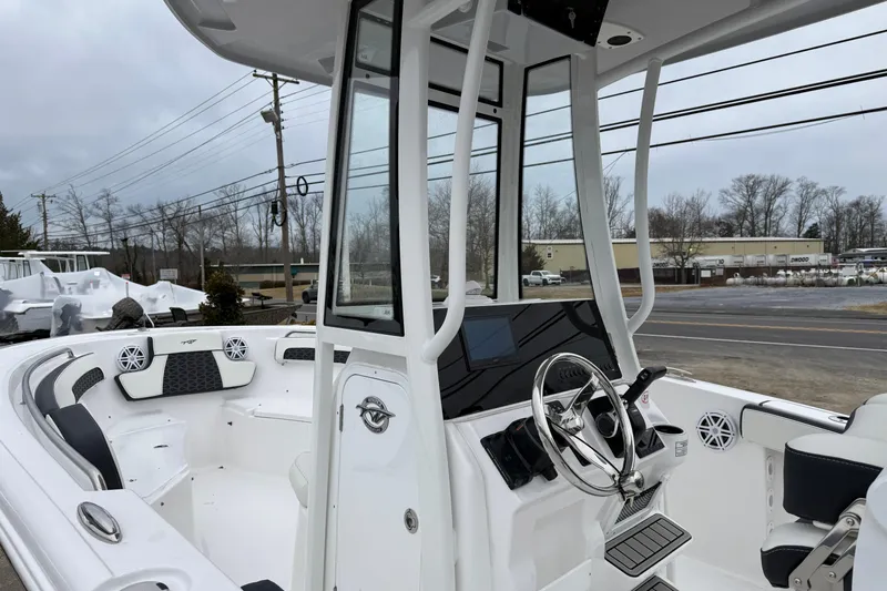 Slide: The Image of 2026 Tidewater 220 CC Adventure boat interior with modern helm and seating. - 19