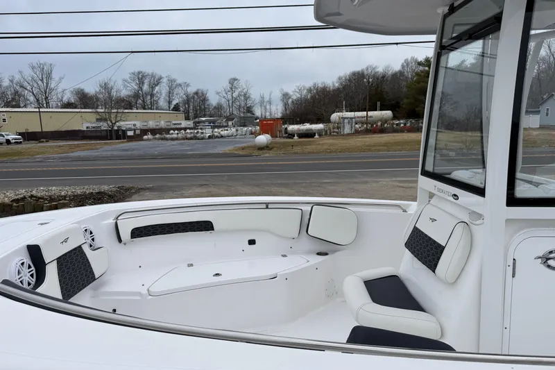 Slide: The Image of 2026 Tidewater 220 CC Adventure boat interior with cushioned seating and modern design. - 20