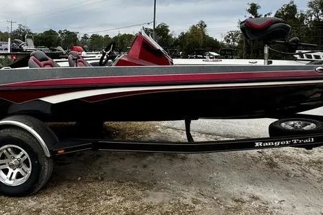 The Image of 2018 Ranger Z185 boat on trailer, red and black design, parked outdoors. - 0