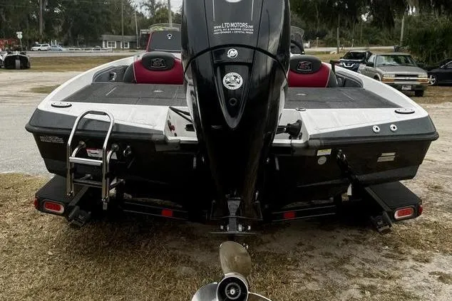 Slide: The Image of 2018 Ranger Z185 boat rear view with motor and ladder on grassy area. - 3