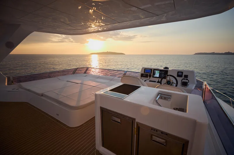 Slide: The Image of Luxurious 2025 Omaya 50 Power Catamaran at sunset, featuring spacious deck and modern controls. - 42